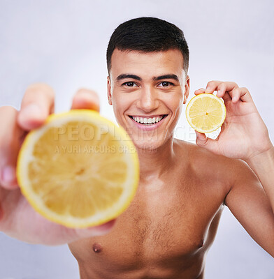 Buy stock photo Beauty, lemon and offer with portrait of man in studio for health, detox and cosmetics. Vitamin c, nutrition and summer with face of person and fruit on white background for self care and skincare