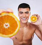 Offer, orange and skincare with portrait of man in studio for health, detox and natural cosmetics. Vitamin c, nutrition and spa with person and fruit on white background for self care, beauty or glow