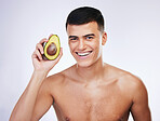 Happy man, portrait and avocado in skincare, health or diet against a white studio background. Male person or model smile with organic vegetable for natural nutrition, eating or healthy wellness