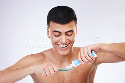 Buy stock photo Happy man, toothbrush and toothpaste for cleaning teeth in dental care hygiene or grooming against a white studio background. Male person smile for tooth whitening, oral or gum and mouth treatment