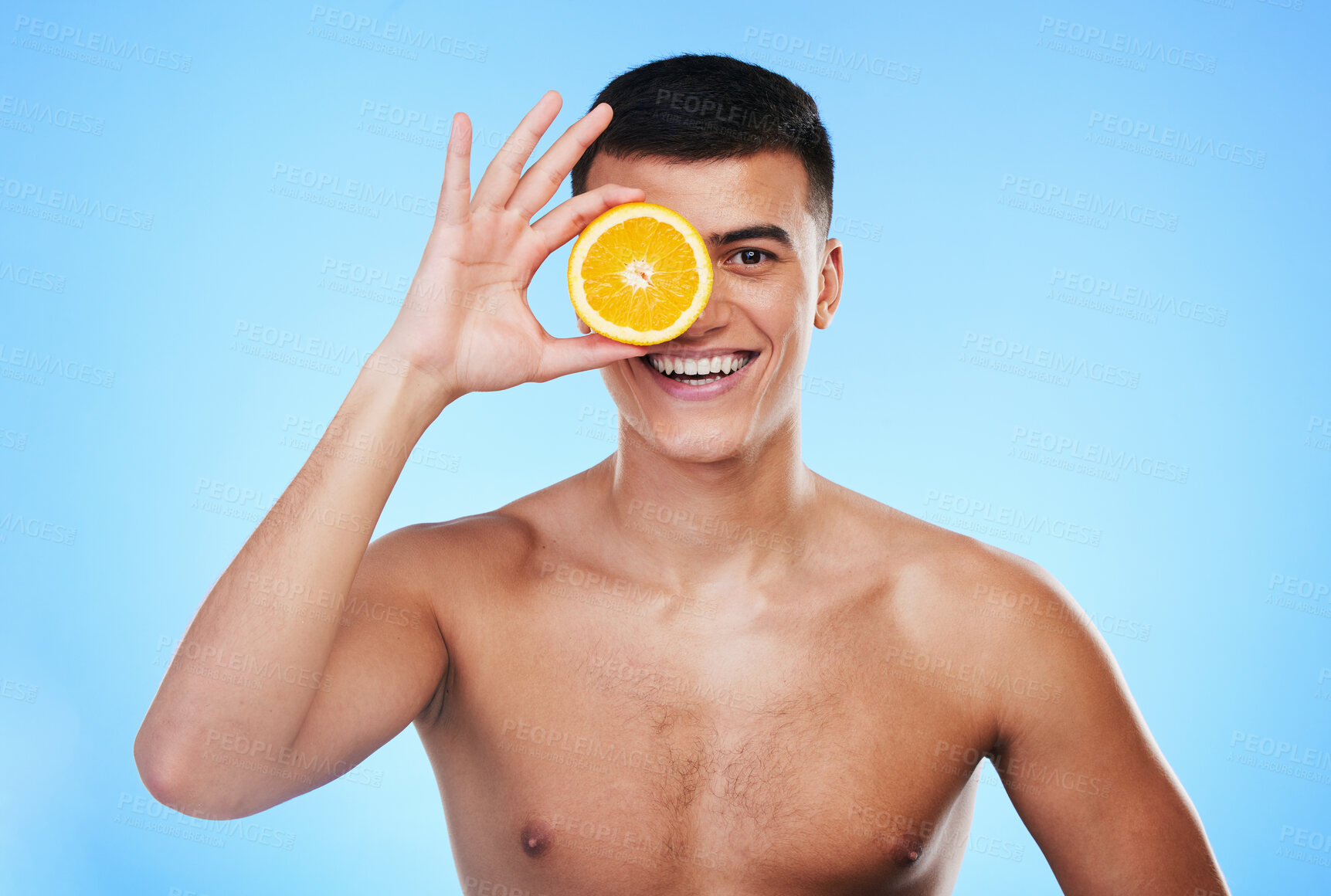 Buy stock photo Beauty, orange and glow with portrait of man in studio for health, detox or natural cosmetics. Vitamin c, nutrition and skincare with person and fruit on blue background for spa and self care mockup