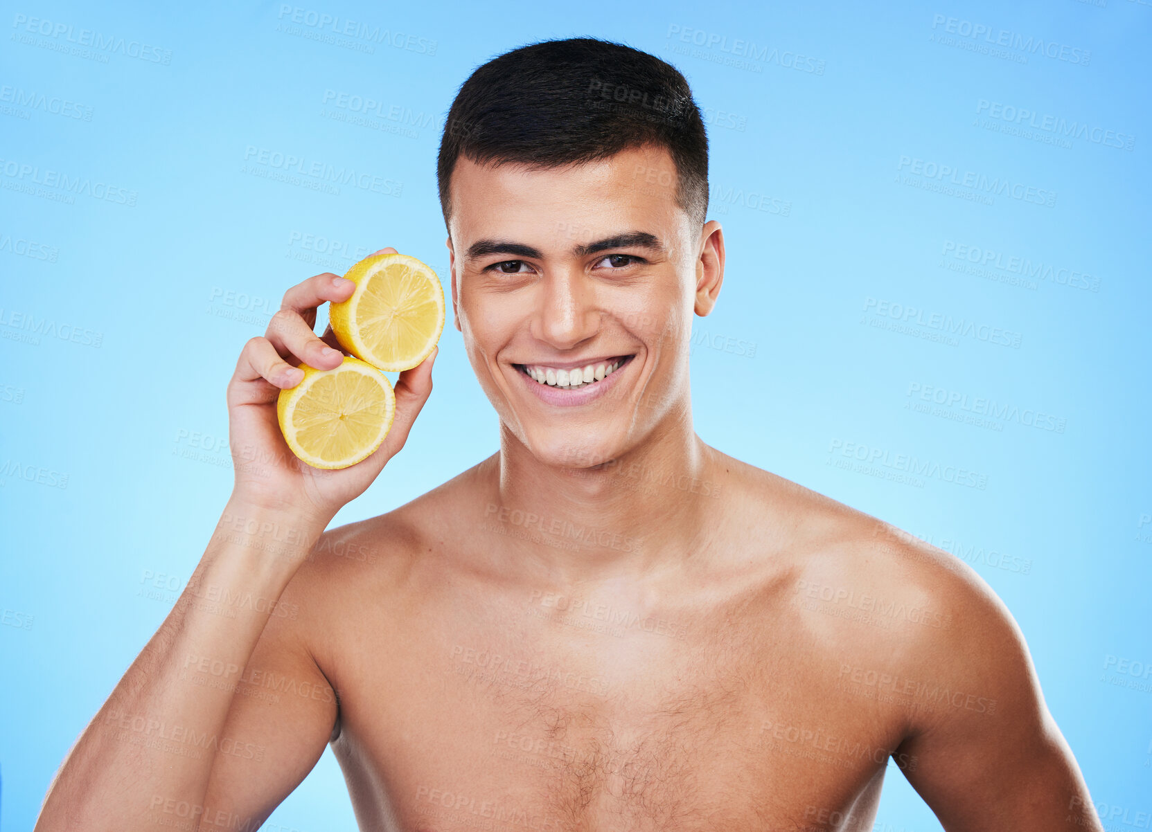 Buy stock photo Beauty, health and portrait of man and lemon in studio for health, detox and natural cosmetics. Vitamin c, nutrition and skincare with person and fruit on blue background for self care, spa and glow 