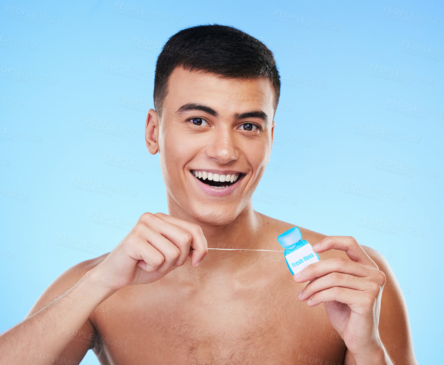 Buy stock photo Happy man, portrait and dental floss for teeth cleaning, hygiene or grooming against a blue studio background. Male person or model smile with flossing in oral, tooth whitening or gum and mouth care