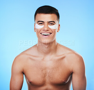 Buy stock photo Happy man, beauty and smile with eye patch for skincare, grooming and clean with hygiene on blue background. Skin treatment, cosmetics product and wellness, portrait and dermatology in a studio