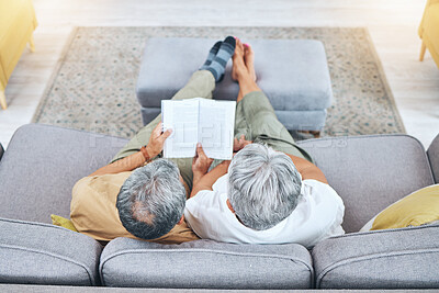 Buy stock photo Relax, retirement and a senior couple reading a book on a sofa in the living room of their home from above. Love, storytelling and elderly people taking a break to study for knowledge or a hobby