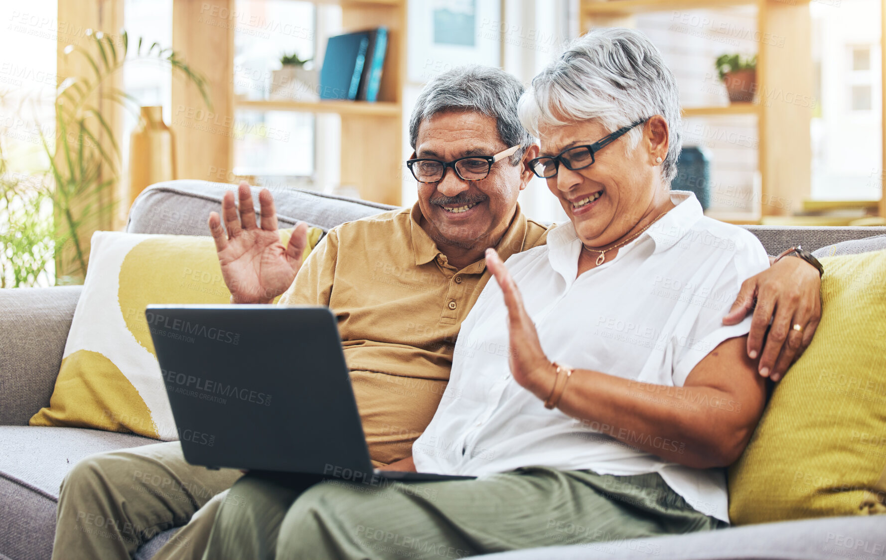 Buy stock photo Senior couple, video call and laptop in home with voip communication, digital chat and talk. Happy man, woman and wave hello on computer in virtual conversation, online contact and retirement on sofa