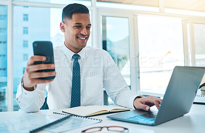 Buy stock photo Laptop, phone and business man typing in office, multitask and working on project. Computer, smartphone and happy consultant on internet, networking on email app and research information on website