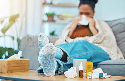 Woman, sick and pills, allergies and medicine with feet on table, healthcare and sinus infection. Virus, bacteria and sneezing, pharmaceutical drugs for illness and tissue, relax on sofa and health