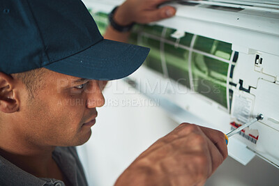 Buy stock photo Face, hand and a man for aircon repair or maintenance in an office for circulation or central heating. Construction, tools or screwdriver with an engineer working on an air conditioning unit closeup