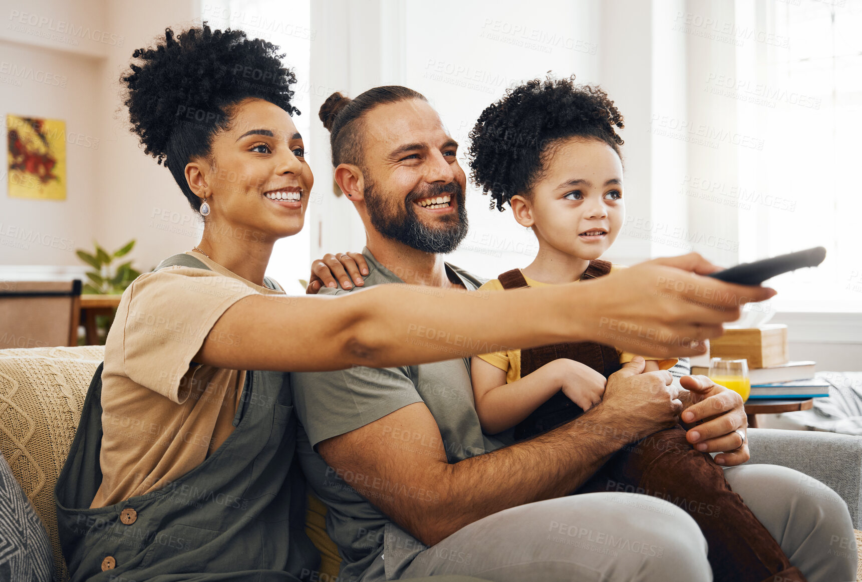 Buy stock photo Interracial parents, child and watching tv on sofa, remote and choice for video, movie or show in living room. Father, mother and kid on lounge couch, comedy and streaming subscription in family home