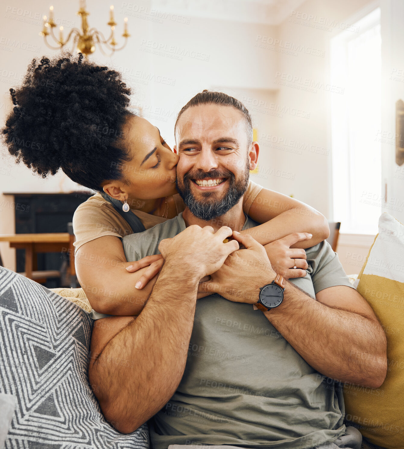 Buy stock photo Happy couple, hug and kiss on sofa in home, living room or bonding in apartment with love in marriage or relationship. Man, smile and woman embrace or support partner on couch or relax together