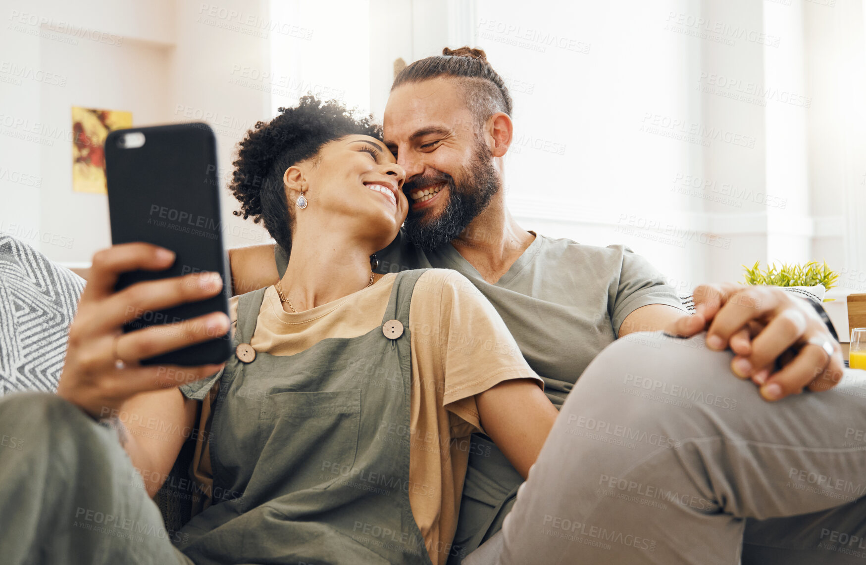 Buy stock photo Interracial couple, selfie and smile on couch, holding hands or laugh with memory, web blog or post on internet. Man, woman and happy for photography, profile picture or love on sofa for social media