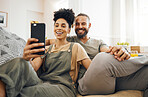 Interracial couple, selfie and smile on sofa, holding hands and together for memory, web blog or post on internet. Man, woman and happy for photography, profile picture and excited for social media