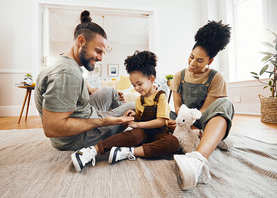 Buy stock photo Happy family, bond and relax on a floor with care, fun and hand game in a home. Love, carpet and boy child with interracial parents in living room playing, learning and development together in house