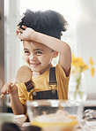 Child in kitchen, baking with wooden spoon and cake flour on face, little baker making breakfast or cookies. Learning, cooking and happy boy chef in home with mixing bowl, tools and smile in morning.