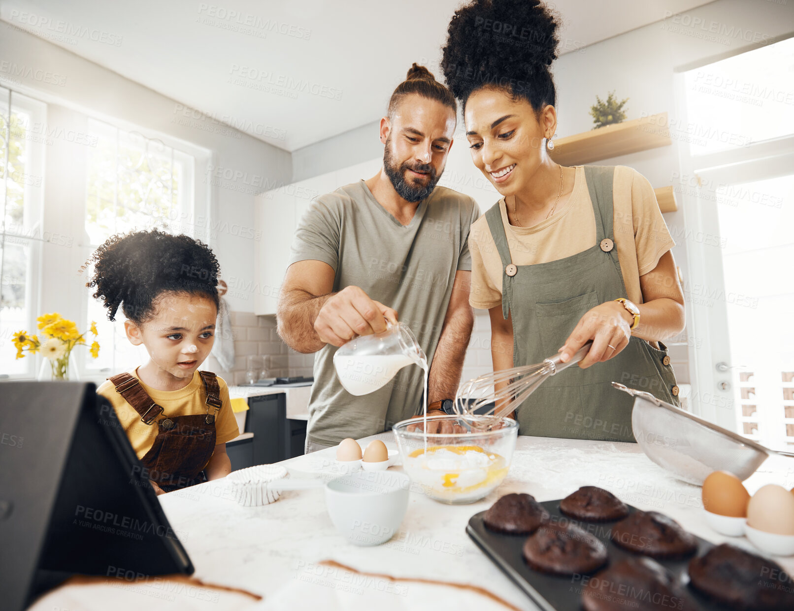 Buy stock photo Child, parents and baking in kitchen, teaching and learning for development at breakfast. Cupcake, cooking and boy in home with happy interracial family, mom and dad and mixing muffins in the morning