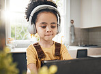 Tablet, headphones and kid in online education in home, elearning or homeschool in kitchen. Serious, technology and boy child on video call, study on internet and listening to music in virtual class