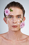 Beauty, skincare and flowers with portrait of man in studio for spring, natural cosmetics and creative. Glow, self love and floral with face of model on white background for makeup, spa and wellness