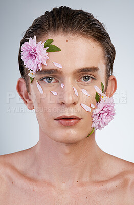 Buy stock photo Beauty, skincare and flowers with portrait of man in studio for aesthetic, natural cosmetics or creative. Glow, self love and floral with face of model on white background for makeup, spa or wellness