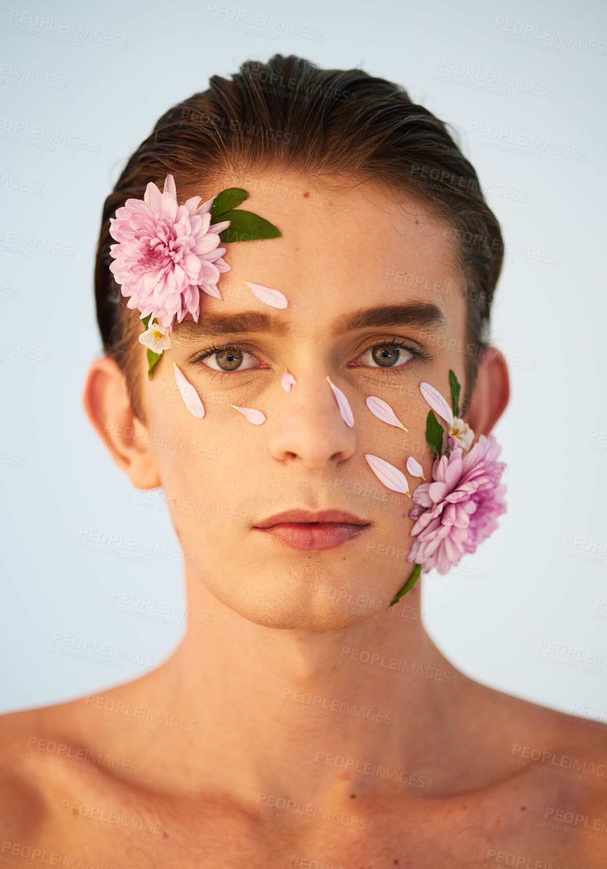 Buy stock photo Floral, skincare and flowers with portrait of man in studio for beauty, natural cosmetics and creative. Glow, self love and spring with face of model on white background for makeup, spa and wellness