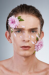 Spring, cosmetics and flowers with portrait of man in studio for beauty, natural skincare and creative. Glow, self love and floral with face of model on white background for makeup, spa and wellness