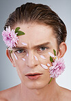 Glow, skincare and flowers with portrait of man in studio for beauty, natural and creative. Self love, cosmetics and spring with face of model on white background for makeup, spa and floral wellness