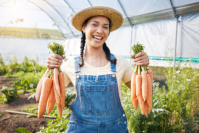 Buy stock photo Greenhouse, portrait of happy woman holding carrots at sustainable small business in agriculture and natural organic food. Girl working at agro farm, vegetable growth in garden and eco friendly pride