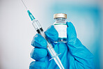 Hand, vaccine and syringe with a doctor in the hospital closeup for healthcare or medication. Medical, injection and treatment with a medicine professional in a clinic for innovation or cure