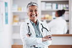 Mature, pharmacist or portrait of happy woman with arms crossed in healthcare clinic or drugstore. Proud, wellness or confident female doctor by pharmacy medication or medicine on shelf ready to help