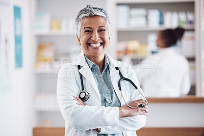 Buy stock photo Mature, pharmacist or portrait of happy woman with arms crossed in healthcare clinic or drugstore. Proud, wellness or confident female doctor by pharmacy medication or medicine on shelf ready to help