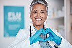Senior, happy woman and portrait of doctor with heart hands in healthcare, service or love at hospital. Mature female person or medical professional smile in happiness, like emoji or sign at clinic