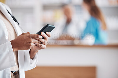 Buy stock photo Pharmacist with phone, typing in clinic and medical information research, email or online chat. Smartphone, networking and mockup, woman doctor in pharmacy checking social media or internet news.