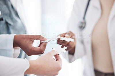 Buy stock photo Doctor, team and hands with puzzle piece connection for solidarity, medical community and teamwork. Hospital, clinic and healthcare group with engagement, support and development of surgeon staff