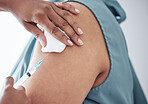 Hands, healthcare and doctor with patient for vaccine in a clinic for medical treatment for prevention. Closeup of a nurse doing a vaccination injection with a needle syringe in a medicare hospital.