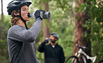 Forest, cyclist and men drinking water, exercise and tired with workout, refreshing and fitness. Healthy people, athlete and bikers in the woods, hydration and outdoor with liquid, bottles and helmet