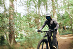Bike, forest and man travel, fast and workout outdoor in woods for healthy body. Mountain bicycle, nature and athlete training, cycling blur or off road adventure on journey, freedom and sport speed