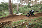 Bike, man in woods and speed blur in workout outdoor at forest for healthy body. Mountain bicycle, nature and fast athlete training, cycling or off road adventure on journey, exercise or sport travel