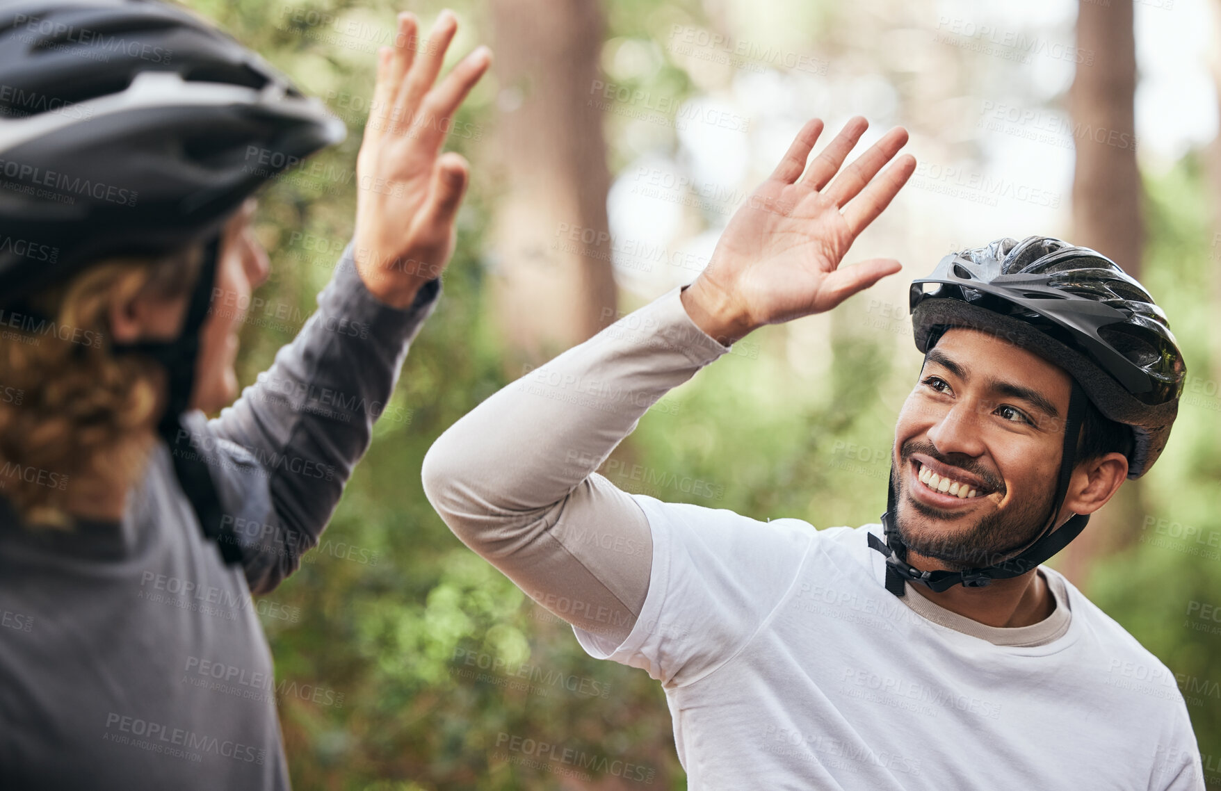 Buy stock photo Forest, cyclist and friends with high five, support and exercise with fitness, smile and motivation. People, men and bikers with gesture, woods and challenge with progress, workout and achievement