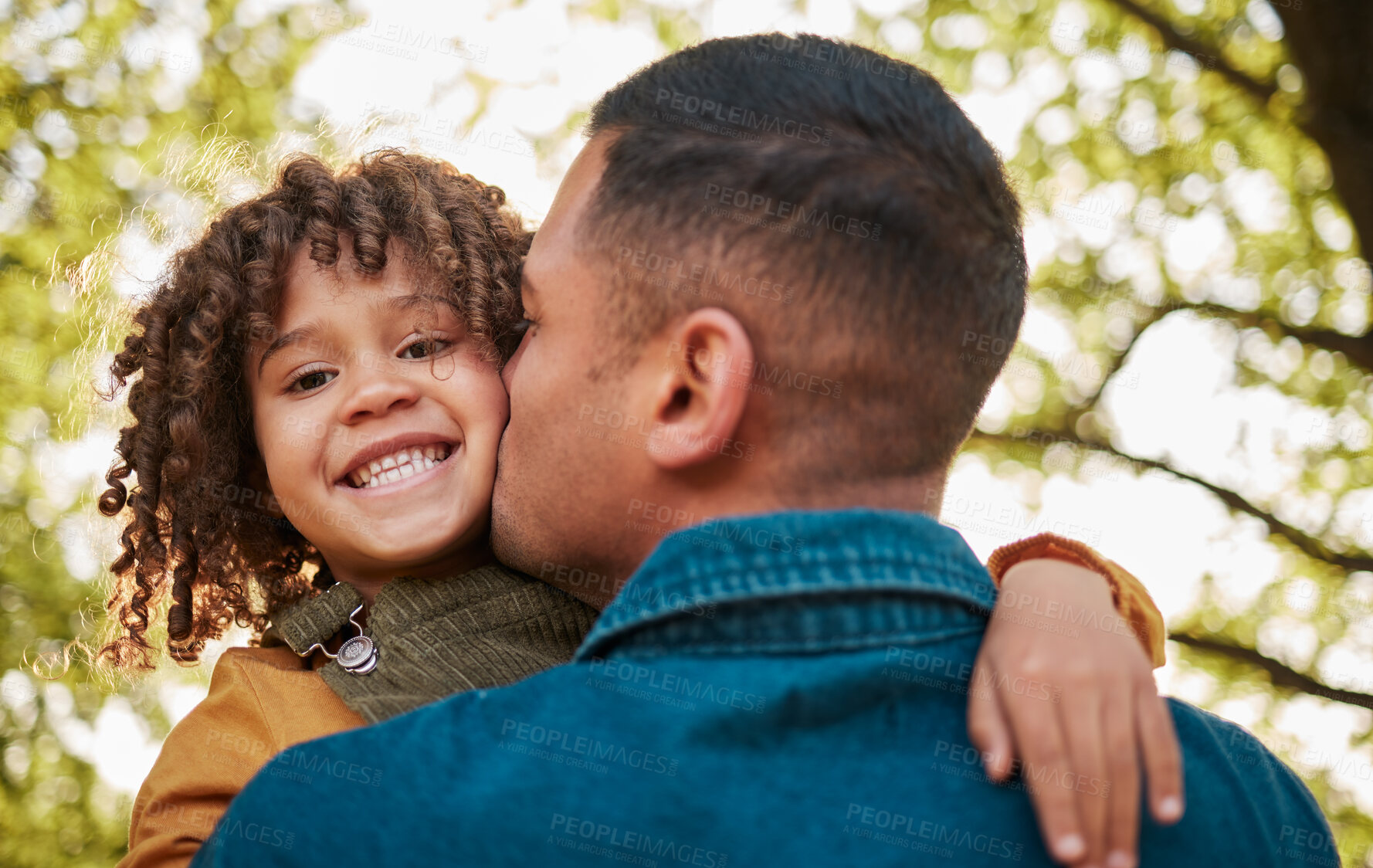 Buy stock photo Kiss, portrait and a child and father in nature with a hug for playing, bonding or family. Happy, together and a young dad with care, love and carrying a girl kid in a park for outdoor walking