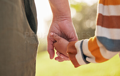 Buy stock photo Parent, child and holding hands for walking in park for support, trust and care together or bonding in nature. Love, comfort and mother help kid in the morning sunshine with kindness on weekend