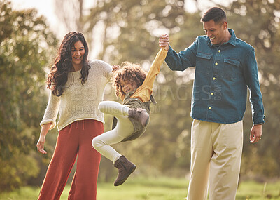 Buy stock photo Holding hands, park and parents playing with girl in nature for fun, bonding and relax together. Happy family, childhood and mother, father and child jump outdoors on holiday, adventure and vacation
