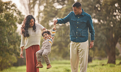 Buy stock photo Holding hands, park and parents play with kid in nature for fun, bonding and relax together. Happy family, childhood and mother, father and young boy jump outdoors on holiday, adventure and vacation