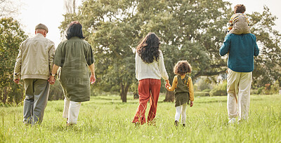 Buy stock photo Love, holding hands and relax with big family in park for bonding, support and summer. Vacation, happy and holiday with people walking in grass field in nature for peace, generations or care together