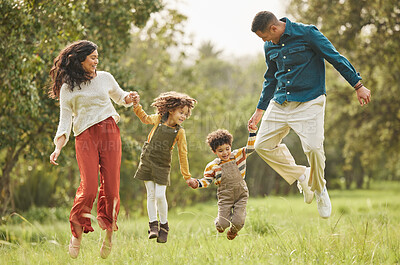 Buy stock photo Holding hands, park and parents jump with children in nature for playing, bonding and fun together in field. Happy family, mother and father with kids outdoors on holiday, adventure and vacation