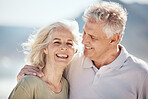Senior couple, laughing and outdoor at beach with happiness, freedom and care on vacation. Face of a man and woman on retirement holiday, adventure and romantic trip in nature to relax and travel