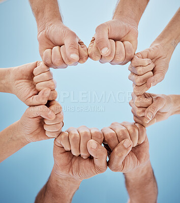 Buy stock photo People, hands together and fist bump in teamwork, unity or community below blue sky background. Low angle, closeup or group goals in team building, motivation or support in trust on mockup space