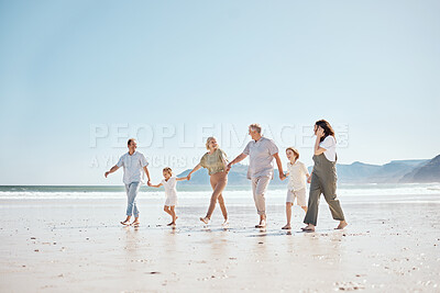Buy stock photo Travel, walking and big family holding hands at the beach on vacation, holiday or adventure together. Bonding, fun and children with parents and grandparents by ocean for fresh air on a weekend trip.