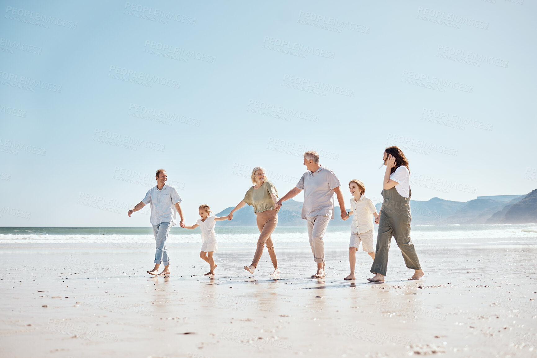 Buy stock photo Travel, walking and big family holding hands at the beach on vacation, holiday or adventure together. Bonding, fun and children with parents and grandparents by ocean for fresh air on a weekend trip.