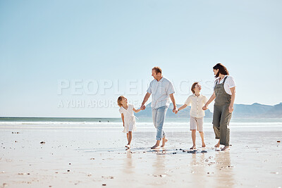 Buy stock photo Travel, walking and family holding hands at the beach on vacation, holiday or adventure together. Bonding, fun and children with their mother and father by the ocean for fresh air on a weekend trip.
