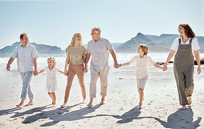 Buy stock photo Happy, walking and big family holding hands at the beach on vacation, holiday or adventure together. Bonding, fun and children with parents and grandparents by the ocean for fresh air on weekend trip